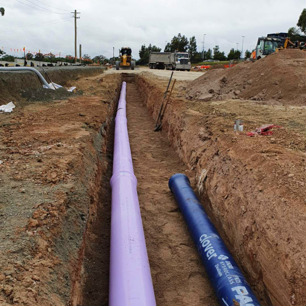 Recycled and potable water ductile iron pipes in a trench