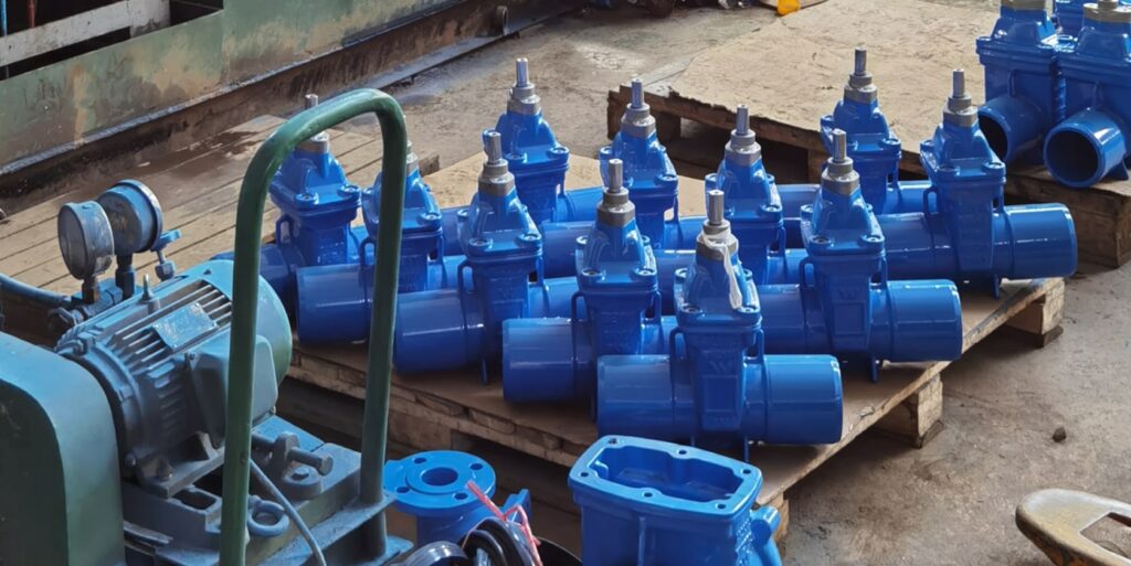 a number of blue water valves on a shipping palette