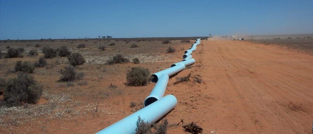 plastic pipeline in trenches dug in baron red soil