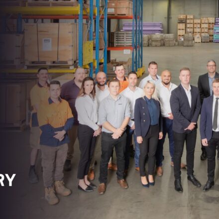 overlay text: 10th anniversary. Clover team standing in a group in the warehouse
