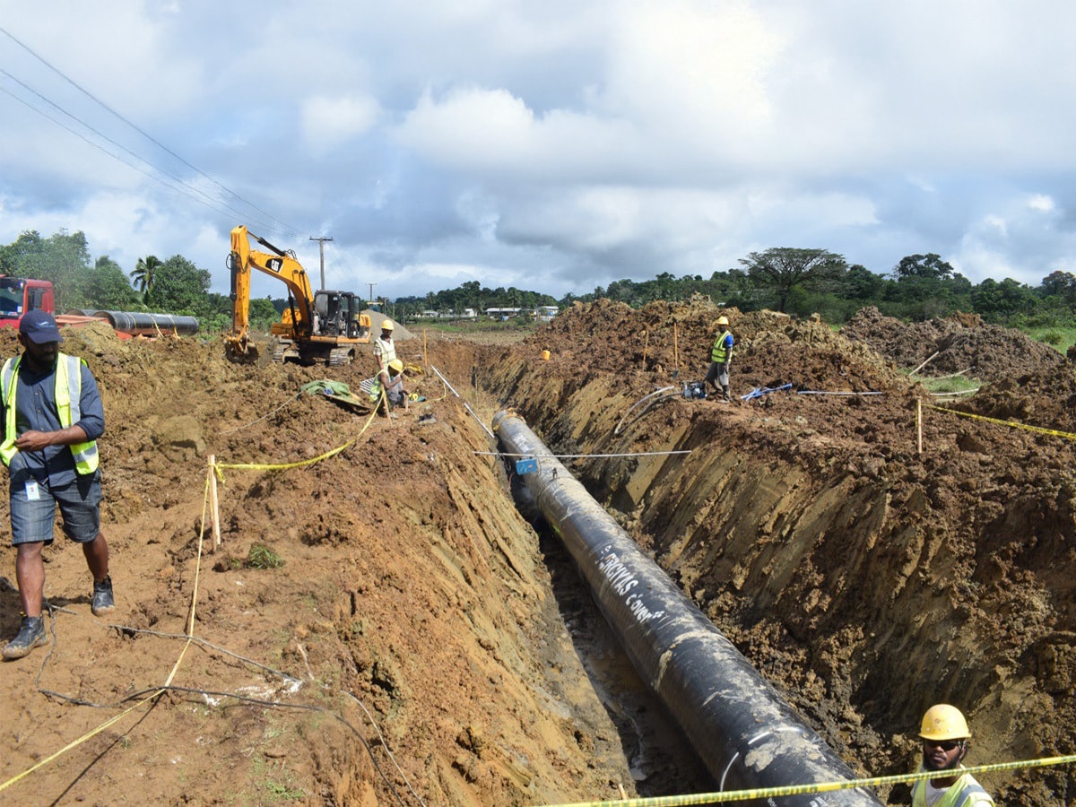 Steel pipe in a trench with installation team