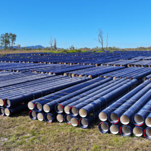 Photo from site showing many ductile iron pipes laid out